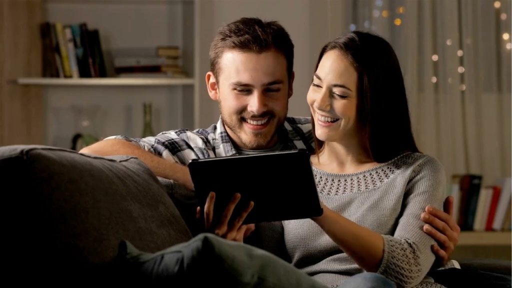 Two customers viewing marketing content on a tablet, illustrating email marketing, customer engagement, personalized communication, and conversion optimization.