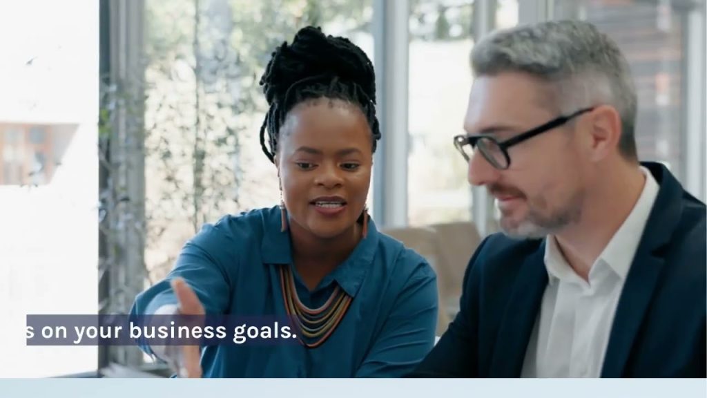 Two business professionals reviewing marketing strategy and discussing lead generation, customer qualification, and business growth.