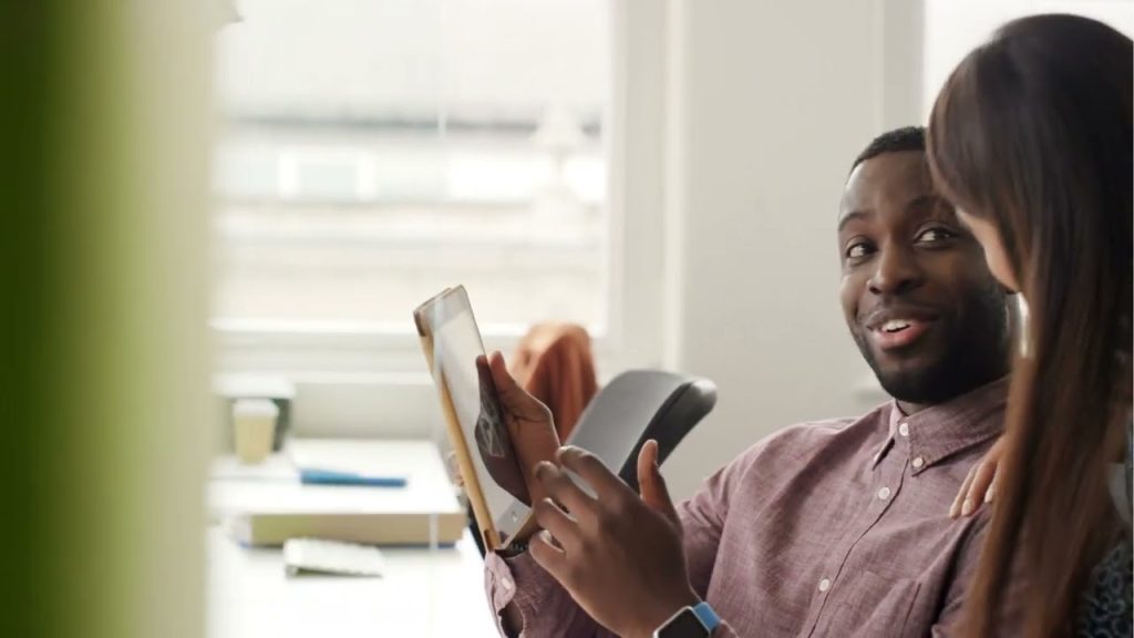 Business professionals reviewing content on a tablet, representing Google Business Profile posts, local marketing, customer engagement, and business growth.